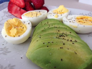 Perfect hard boiled eggs, sliced avocado, and fresh berries for breakfast
